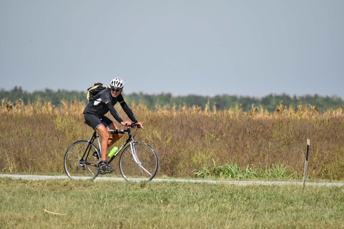 Man riding bike in casual cycling clothing